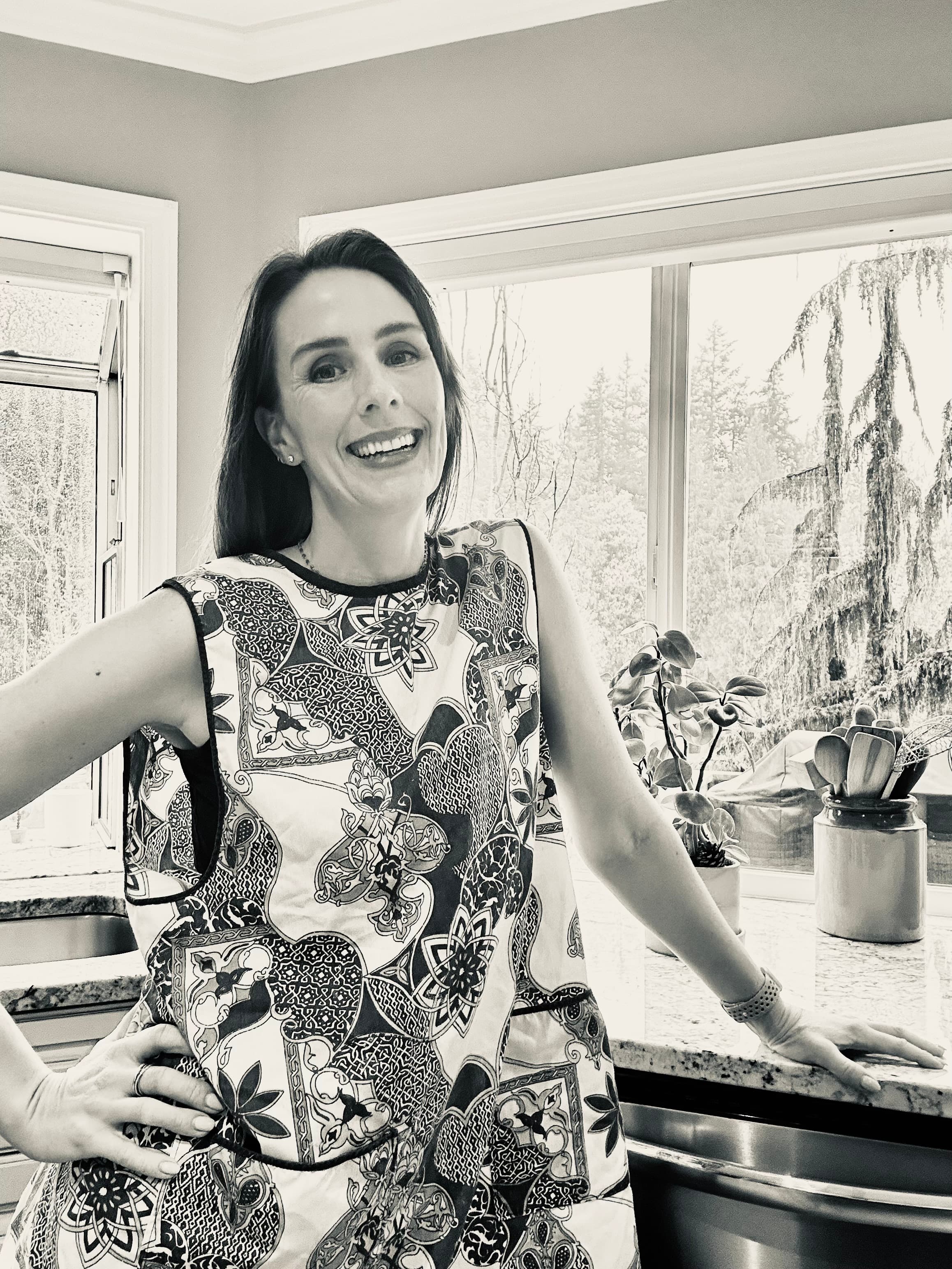 Chesa standing in a bright kitchen beside the counter and windows